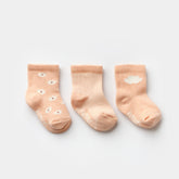 3-pack of baby socks in salmon pink tones with floral, striped, and cloud